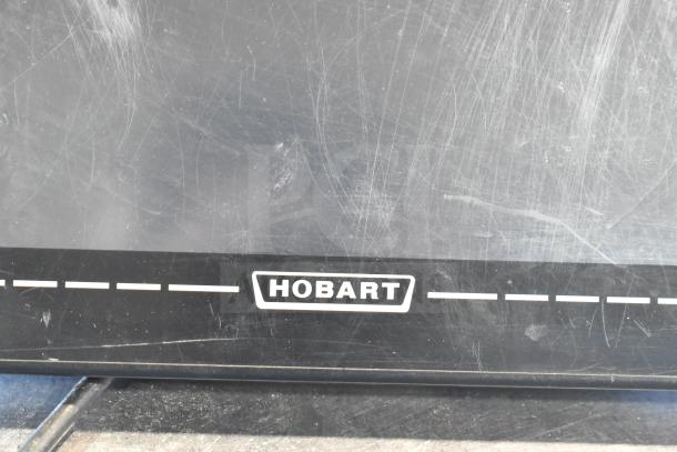 2017 Hobart HTi-7LH26 countertop food scale, 120/208-240V, non-functional, black surface with scratches.