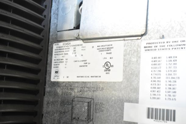 Manitowoc SD0452A Ice Machine Head on SPA310 Dispenser, 115V, 1 Phase, model label with specs visible.