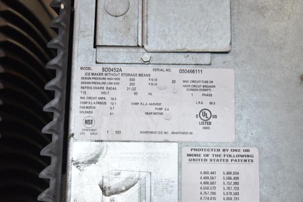 Manitowoc SD0452A ice machine with SPA310 dispenser, 115V, 1 phase. Label indicates R404A refrigerant, NSF, UL listed.