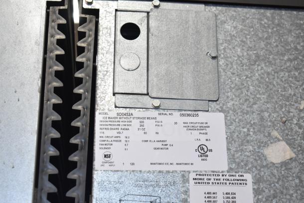 Manitowoc SD0452A ice machine label showing model, serial number 050360235, 115 volts, 1 phase, R404A refrigerant.