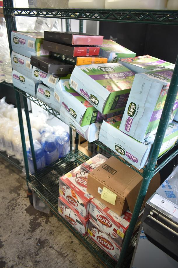 Two-tier shelf with Black Forest Gummies boxes and Boost drinks cartons, various items. Auction lot includes ballet flat shoes.