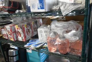 Tiered shelf with Boost drinks, GoJo Luxury Foam Handwash, and various sealed items. Items appear in original packaging.
