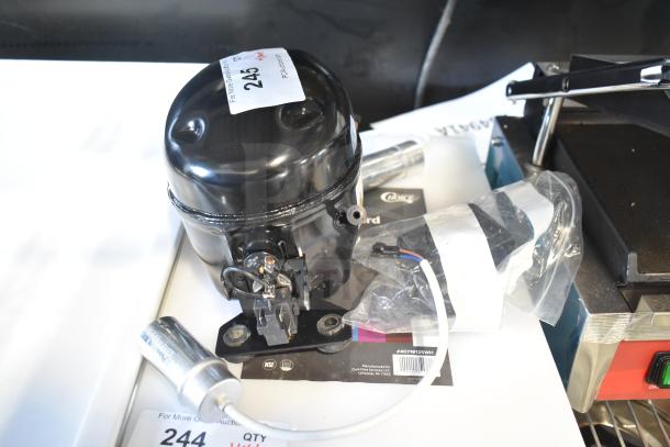 Brand new Cubigel NUT70NR motor, 115-127 volts, 1 phase, scratch and dent, tags indicate auction lot number 245.