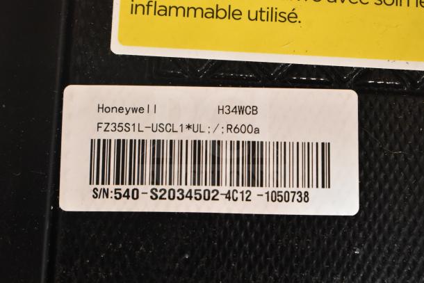 Honeywell H34WCB Wine Cooler label, 34-bottle capacity, shows model and serial number. Potential damages noted.