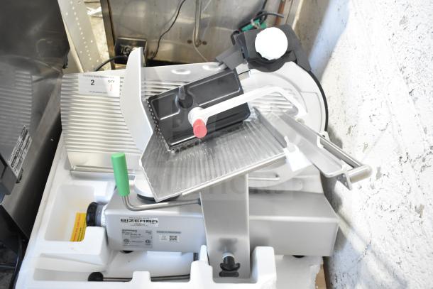 New Bizerba GSP HD meat slicer; 2023 model, 120 volts, 1 phase, commercial-grade, pristine condition, tags show electrical specs.