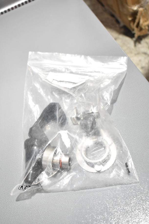 Plastic bag containing parts for Hatco C-27 Booster Water Heater, visible connector and washer.