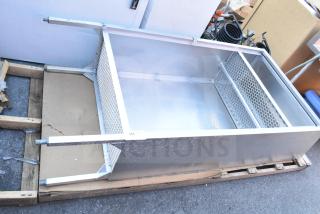 Metal locker cubby with mesh sides on wooden pallet, in good condition. Rugged metal finish, ideal for storage use.