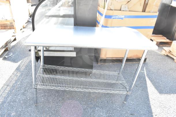 Commercial metal table with wire under shelf, used condition. Ideal for storage and workspace efficiency.