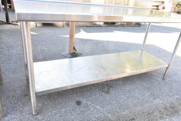 Commercial stainless steel table with under shelf and backsplash. Good condition, ideal for kitchen use, sturdy construction.