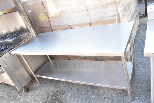 Stainless steel commercial table with under shelf, ideal for kitchen use. Used condition, sturdy frame, minimal wear.