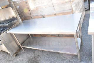 Stainless steel commercial table with under shelf, ideal for kitchen use. Used condition, sturdy frame, minimal wear.