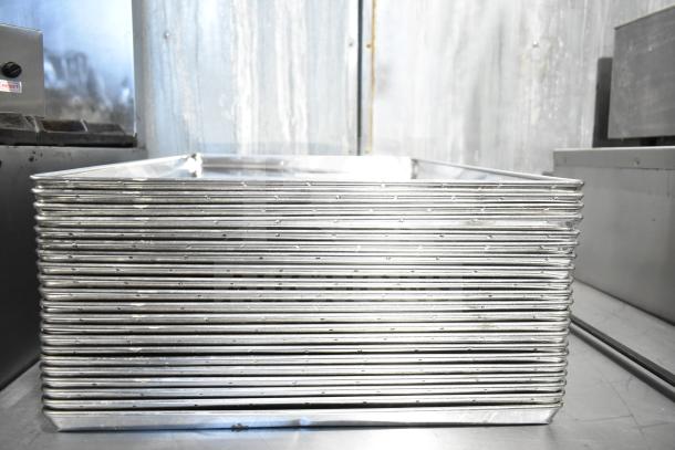 21 full-size aluminum baking pans stacked, good condition, ideal for commercial kitchens. Auction offers 21 times bid value.