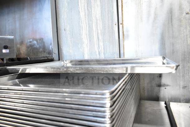 21 full-size baking pans in metal, stacked, slightly used, great for bulk kitchen needs. Multiply bid by 21.