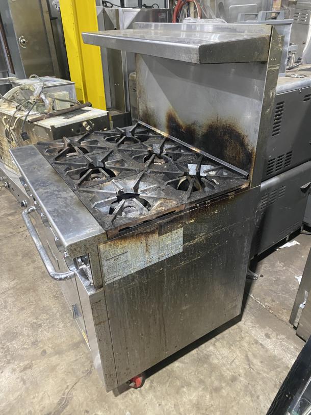 Migali C-RO6B-NG stainless steel commercial gas stove with 6 burners, oven, raised backsplash, salamander shelf, on casters.