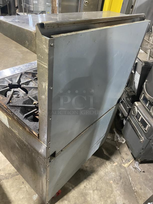 Migali commercial 6-burner gas stove, model CRO6B, with raised backsplash, salamander shelf, oven, on casters, stainless steel.