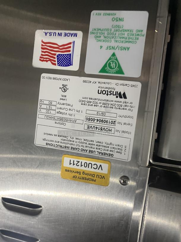 Winston stainless steel insulated cabinet model HOV514UVE with tags showing serial number, certifications, and power specs.