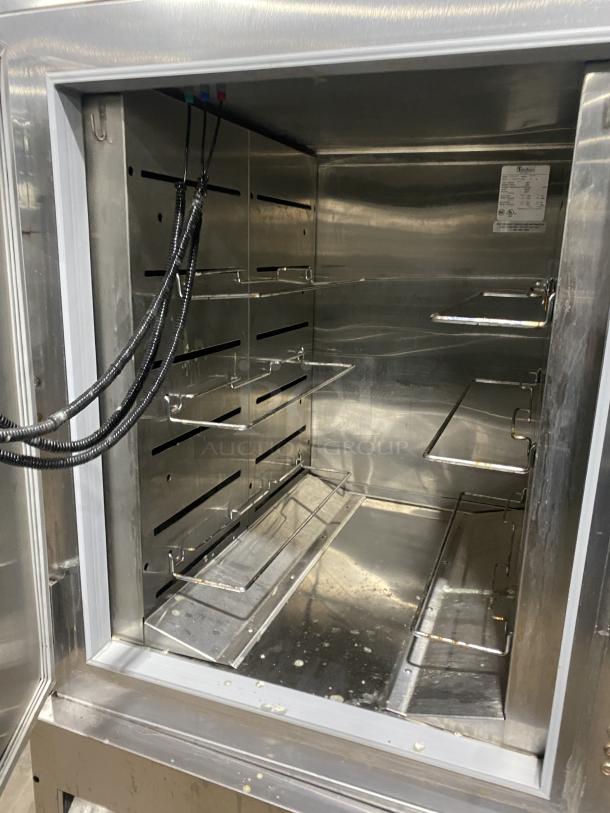 Traulsen RBC100 stainless steel blast chill freezer in used condition, on casters, interior view showing shelves and wiring.