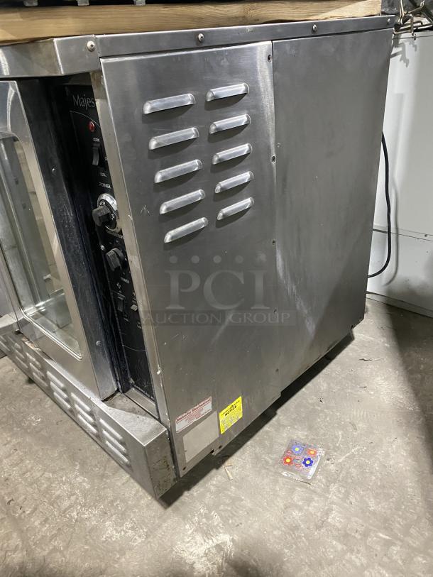 Majestic Series stainless steel single stack convection oven, commercial grade, with wired racks, in good condition.