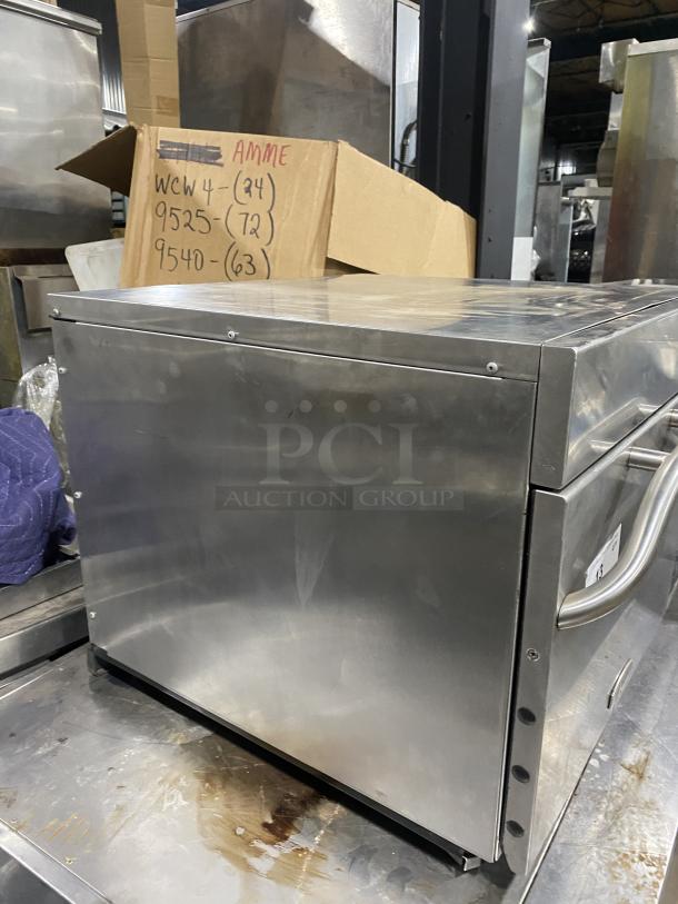 Amana Commercial Stainless Steel Countertop Microwave Oven, Model AXP22. Visible handle, robust design, good condition.