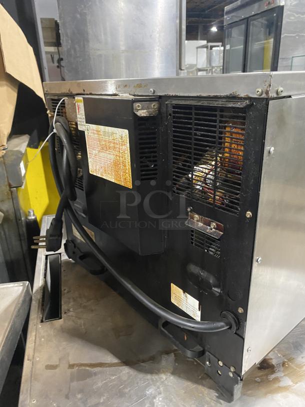 Amana AXP22 commercial stainless steel countertop microwave oven, model AXP22, 208-230V, pre-owned, visible wiring and vents.