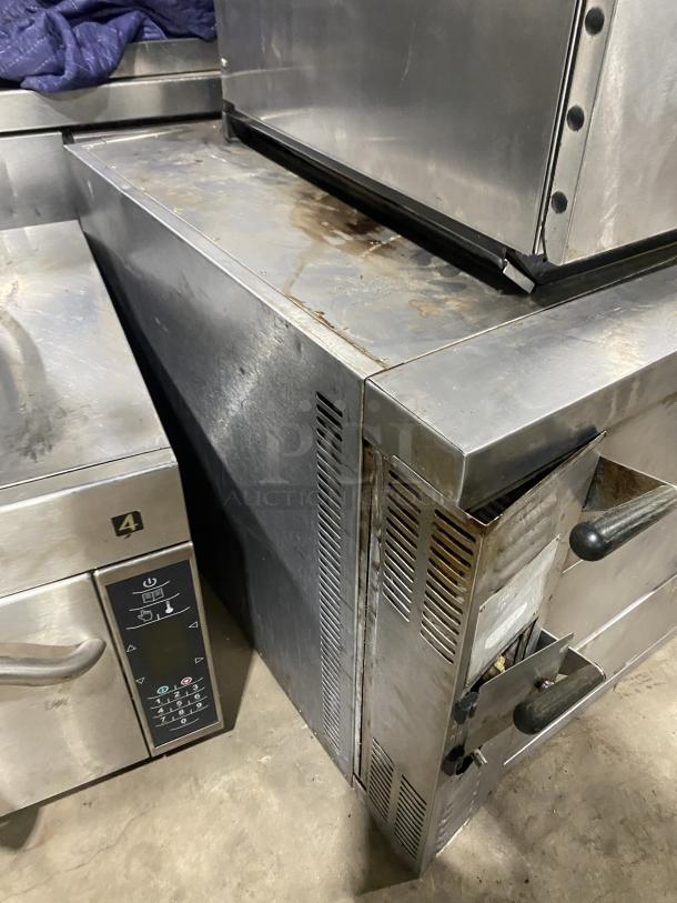 Amana GP-61 stainless steel countertop pizza and bake oven with two baking chambers, used condition, visible wear.