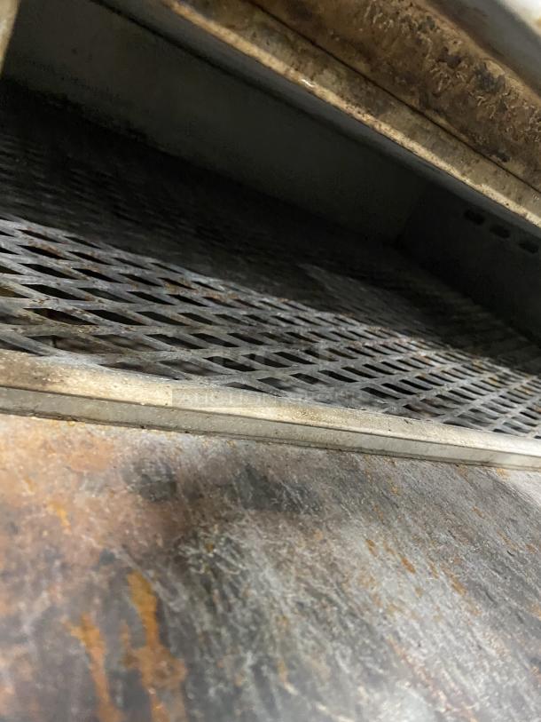 Amana GP-61 commercial stainless steel countertop oven, dual baking chambers, visible interior grates, worn condition.