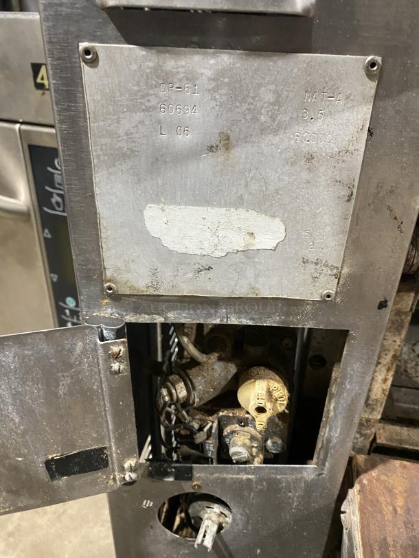 Amana GP-61 stainless steel pizza & bake countertop oven with two chambers, visible wear, model and settings labels shown.