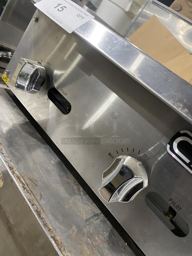 Cayvo Commercial Stainless Steel Gas Char-Rock Broiler, Model CVCB-24LP, featuring control knobs and pilot indicators, in good condition.