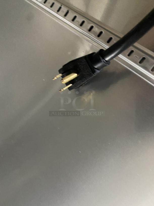 Stainless steel surface of a True Freezer T-23F-HC, showing a power plug. Model T-23F-HC, SN: 8761908, 115V 1PH.