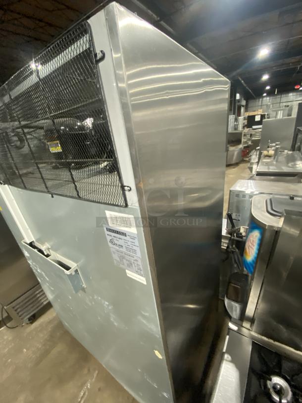 Maxx Cold MXCF-49FD stainless steel commercial freezer with two solid doors, six shelves, on casters. Model label visible.