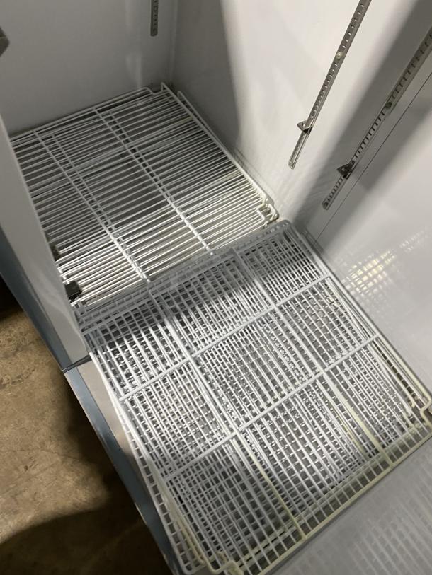 Maxx Cold stainless steel reach-in freezer, model MXCF-49FD, with 6 wire shelves and solid double doors, on casters.