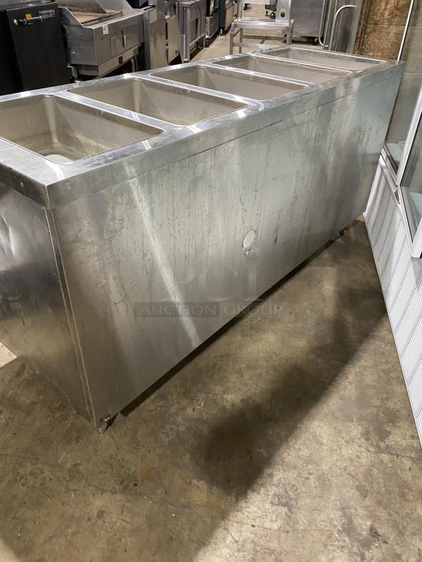 Duke commercial stainless steel electric hot food table, model E305-25SS-SWM, with 5 top openings, on legs.