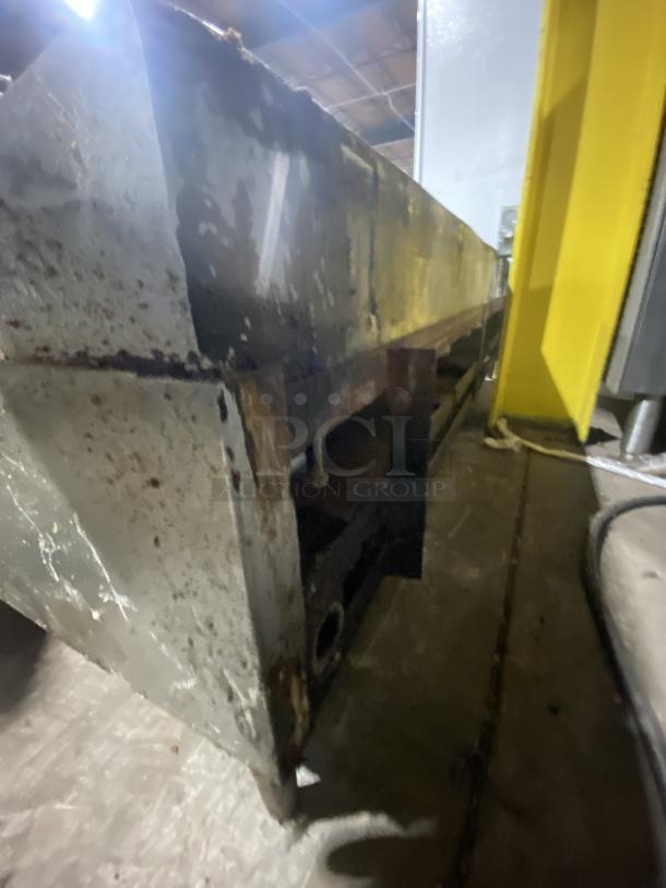 Garland stainless steel countertop griddle on legs, used condition, visible rust and wear, commercial kitchen equipment.