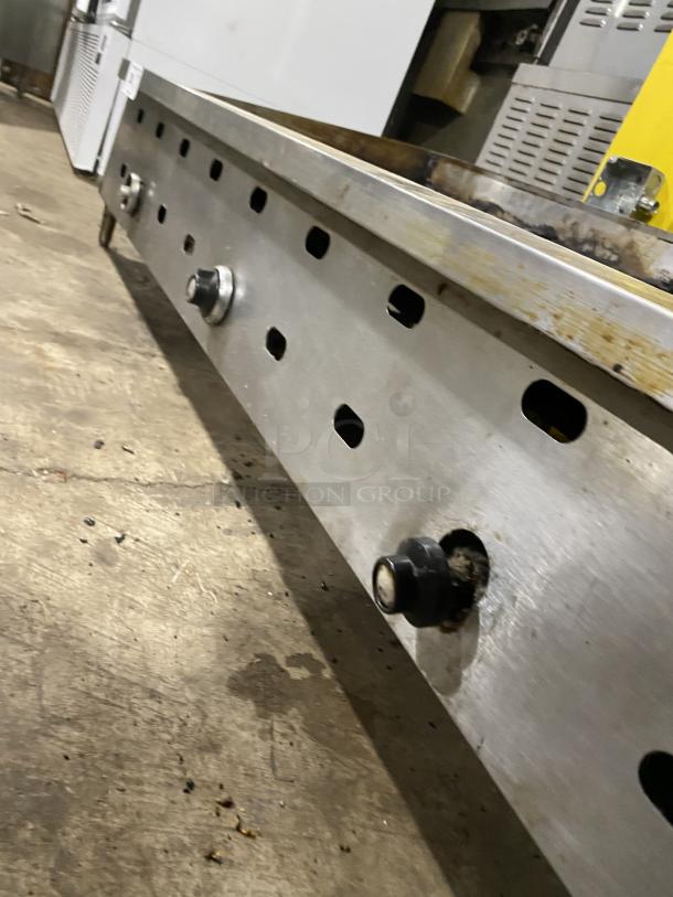 Garland commercial stainless steel countertop griddle on legs, featuring control knobs. Slight wear visible, ideal for kitchens.