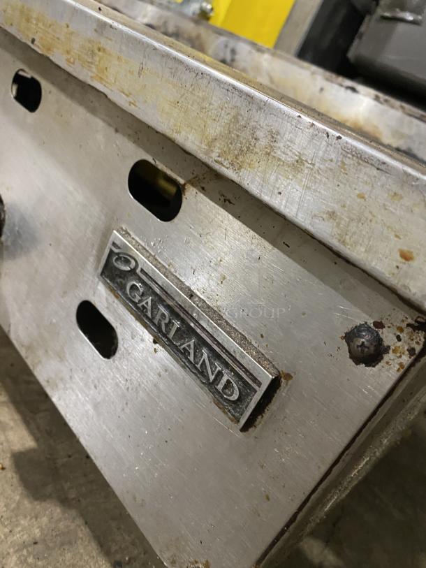 Garland Commercial Stainless Steel Countertop Griddle on legs, showing visible wear and branding.