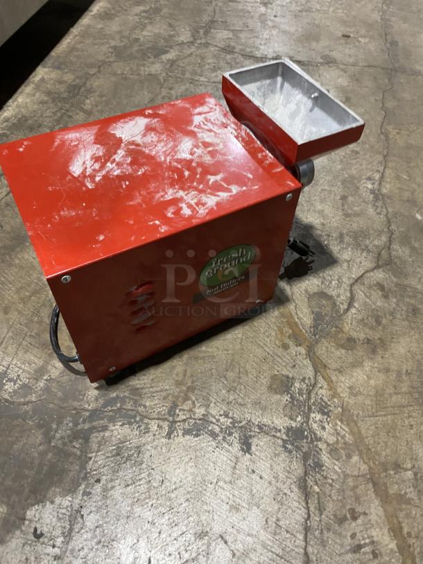 Olde Tyme peanut butter grinder, model PN2, red body, visible wear. Serial: A16070912, 115V, 1 phase, Fresh Ground label.