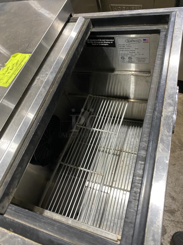 Krowne MC24S stainless steel underbar glass froster, sliding-top lid, visible tags, model and serial number displayed.