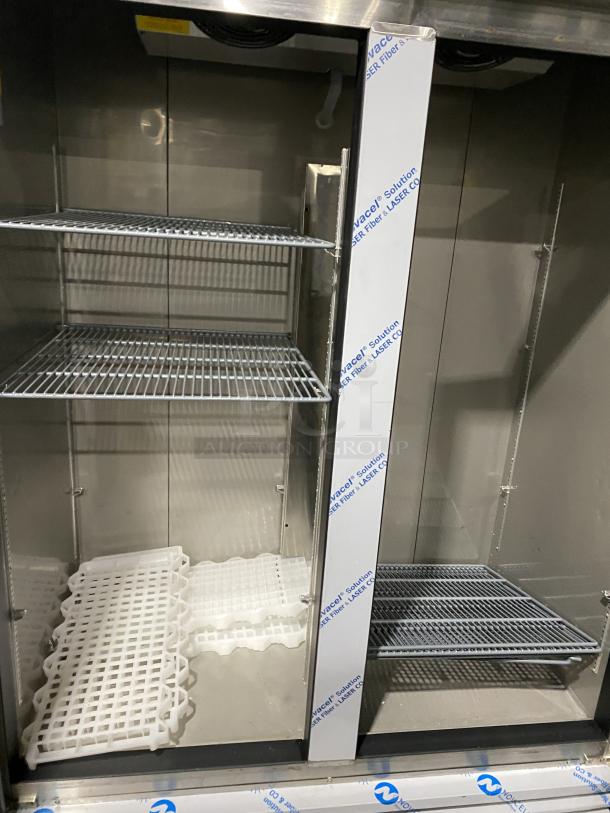 Kutano KUTF 2 SS stainless steel reach-in freezer with two doors, wire shelves, and protective film. Model 115V, 1 Phase.