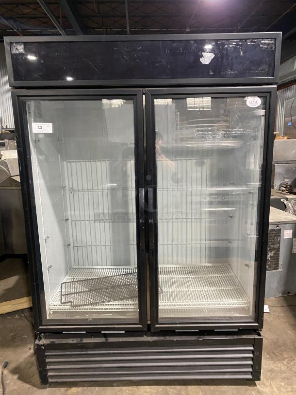 True commercial freezer, model GDM-49F-HC-TSL01. Black stainless steel body, 2 glass doors, used. Serial: 9159869.