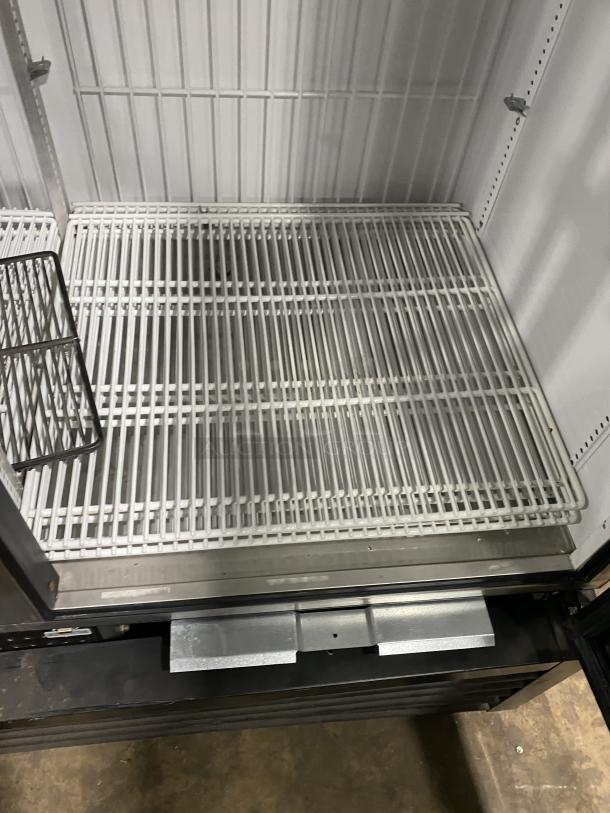 True commercial freezer, model GDM-49F-HC-TSL01, stainless steel, all black body, two glass doors, interior shelves shown, SN: 9159869.