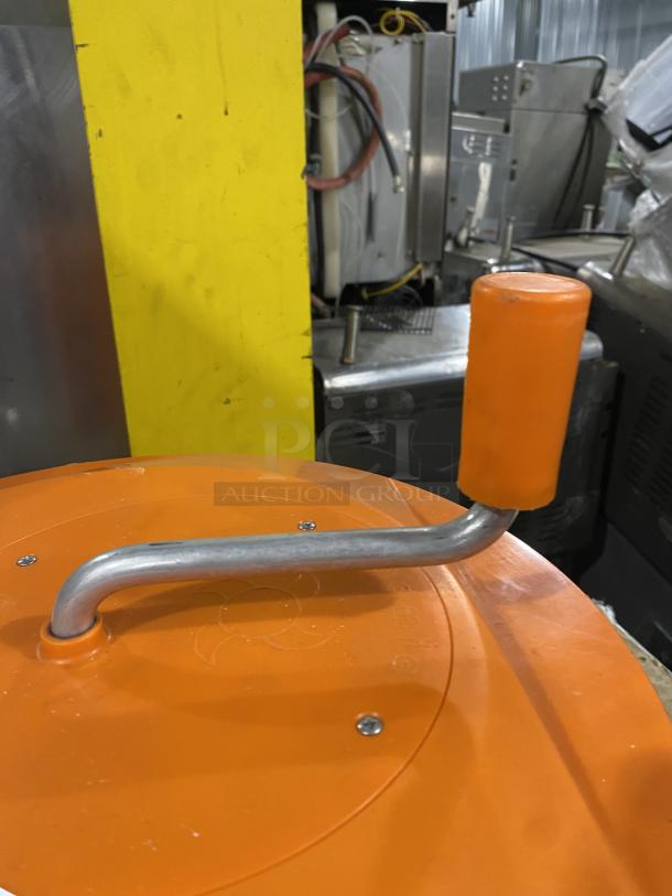 Orange commercial salad spinner with metal hand crank, used condition. Ideal for drying large quantities.