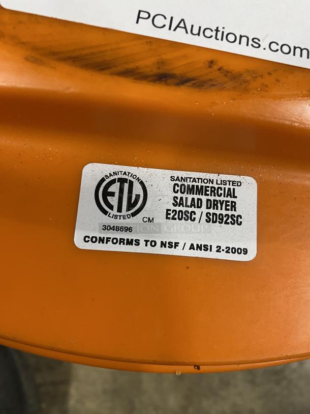 Orange commercial salad dryer with label. Model E20SC/SD92SC. Sanitation listed, conforms to NSF/ANSI 2-2009.