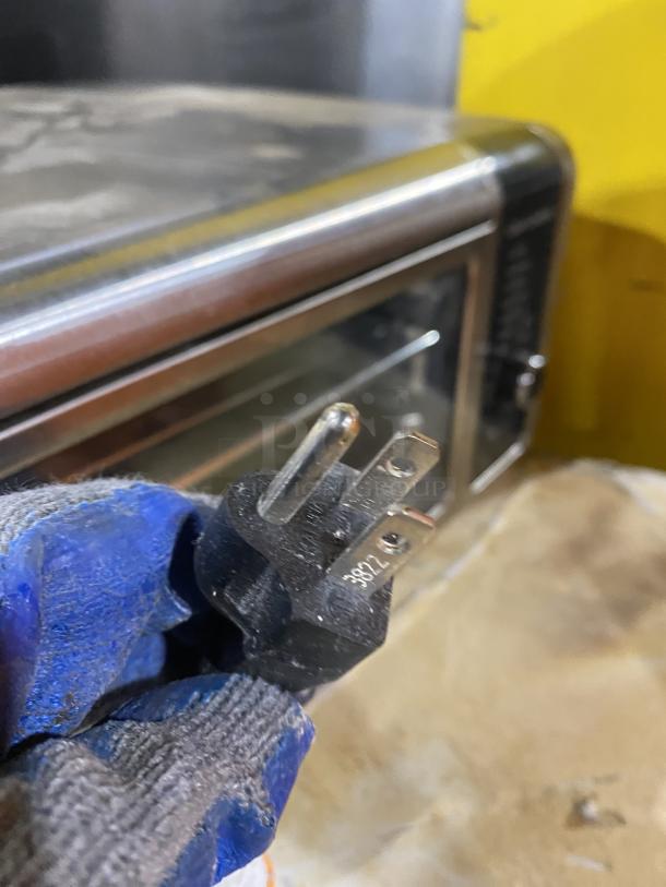 Ninja FT102CO countertop digital air fry oven with view-through door, 120V. Shown with three-prong plug.