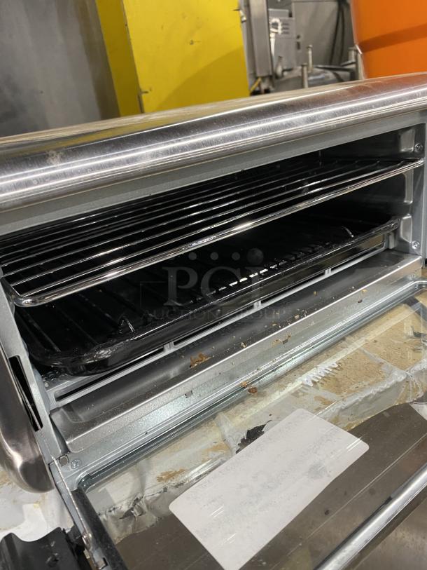 Ninja FT102CO Countertop Digital Air Fry Oven with view-through door, 120V, stainless steel, open showing racks.