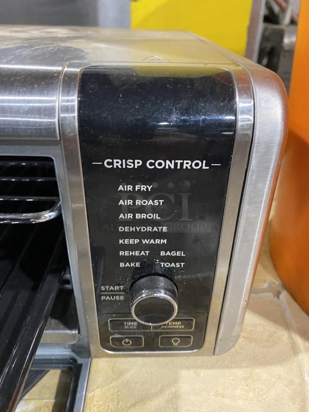 Ninja Countertop Digital Air Fry Oven, Model FT102CO, with view-through door, crisp control panel, and multiple cooking modes.