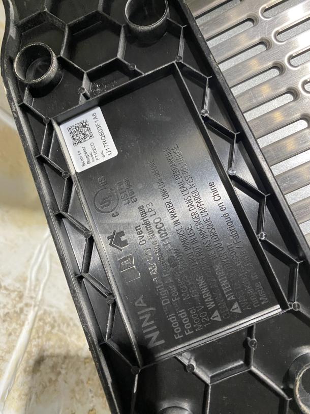 Ninja Countertop Digital Air Fry Oven base with model FT102CO label, serial U17RQ603F1A6, and 120V marking.