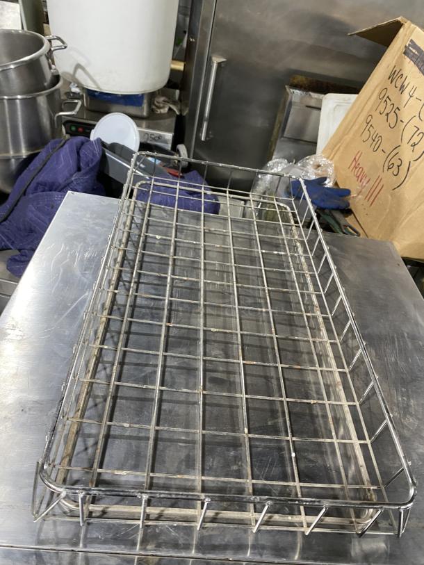 Chrome plated full-size wired rack for bagels/pastry, commercial use. Durable, in good condition, visible wireframe design.