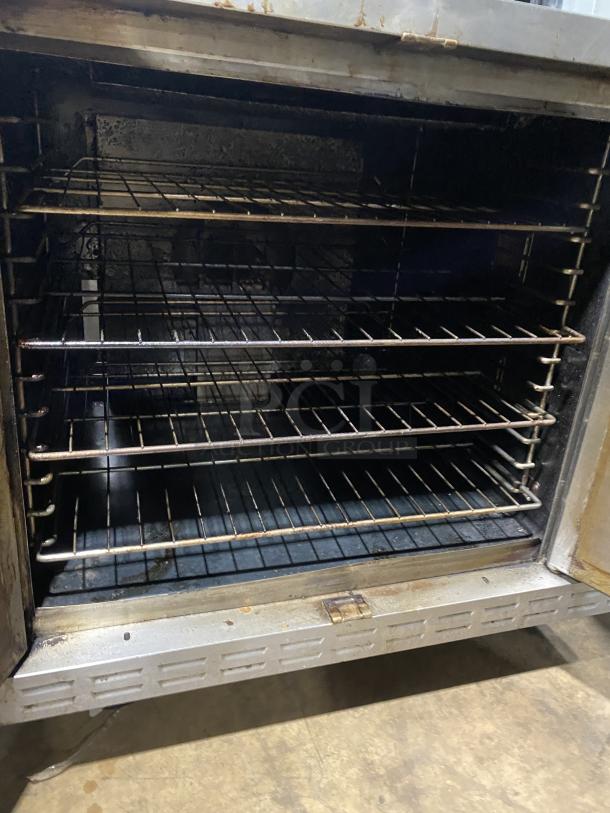 Alto-Shaam commercial stainless steel natural gas oven with wired rack, on casters. Serial No: 710358-002. Good condition.