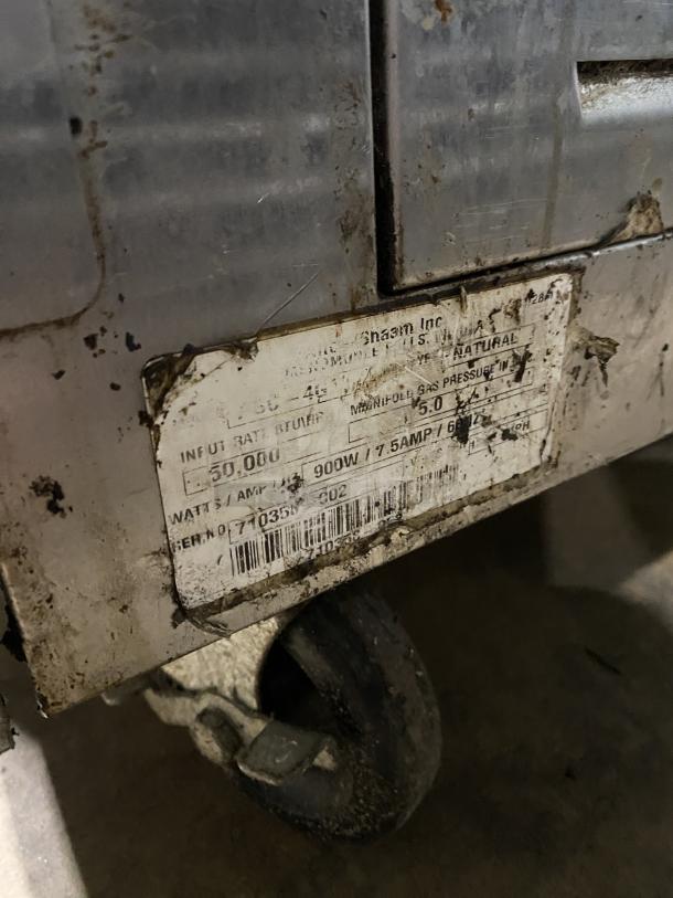 Alto-Shaam commercial stainless steel natural gas oven, SN: 710358-002, with wired rack, 110-115V, on casters, used condition.