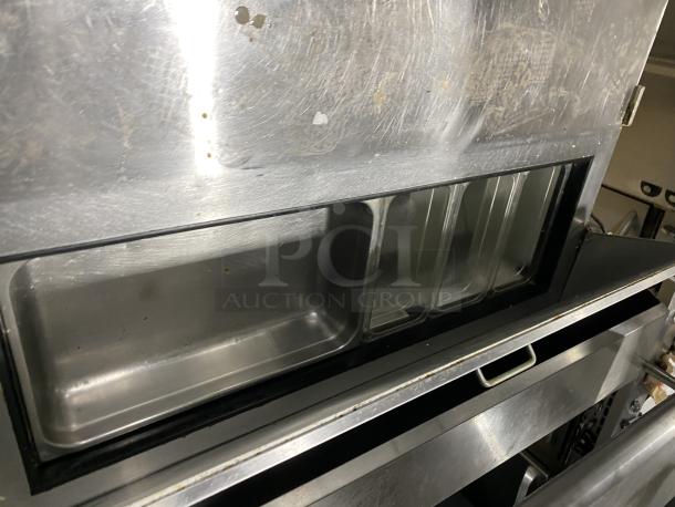 Hoshizaki CRMR48-12 stainless steel refrigerator with top rail, commercial model in used condition, visible wear on surface.